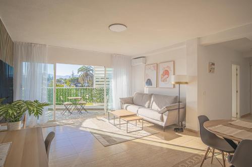 a living room with a couch and a table at Buenti Apartments Beach Beautiful view in Marbella
