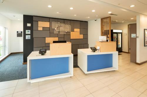 a lobby with boxes on the wall in a building at Holiday Inn Express & Suites - Kalamazoo West by IHG in Kalamazoo