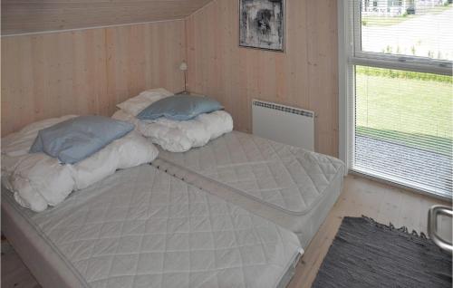 two bunk beds in a room with a window at Beautiful Home In Sydals With 3 Bedrooms, Sauna And Wifi in Skovby
