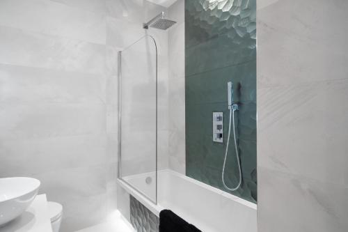 a bathroom with a shower with a glass door at LiveStay - Modern & Stylish Apartments in Oxfordshire in Didcot