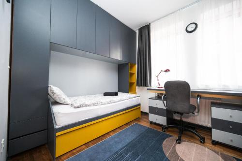 1 dormitorio con litera, escritorio y silla en Luxury Design 2BDR Apartment, en Sarajevo