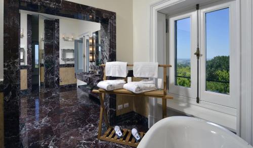 a bathroom with a large window and a sink at Villa Amagioia by Palazzo di Varignana in Varignana