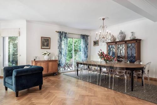 une salle à manger avec une table et une chaise bleue dans l'établissement Villa Stella - 10 chambres - 5 salles de bains - Château de Versailles à pied, à Le Chesnay