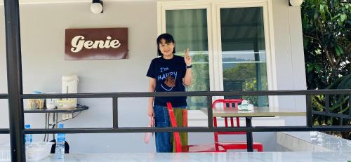 a young boy standing in front of a house at Panutsaya Homestay in Wang Nam Khieo