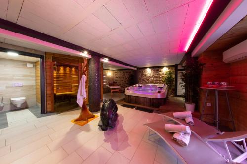 a bathroom with a purple tub in a room at Le Domaine du Verger gîtes et SPA in Osenbach