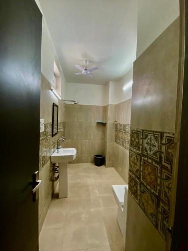 a bathroom with a sink and a ceiling fan at hello Namaste India-Elite in Jaipur