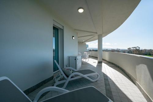 a balcony with chairs and a view of the city at Milena Suite Apartments in Alghero