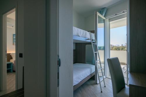 a bunk bed in a room with a balcony at Milena Suite Apartments in Alghero