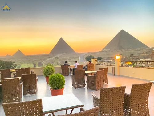 a view of the pyramids from the balcony of a hotel at Egypt Pyramids Inn in Cairo