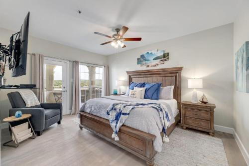 a bedroom with a bed and a chair and a ceiling fan at ILT 3221 Lakeside Serenity in Lago Vista