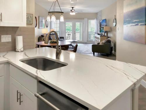 a kitchen with a sink and a living room at ILT 3221 Lakeside Serenity in Lago Vista