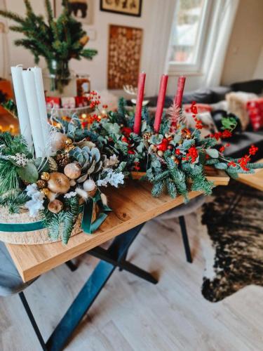a table with christmas decorations and candles on it at Chata Jelení dřevěnice s vlastní vířivkou in Horní Halže