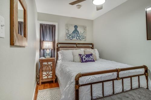 a bedroom with a bed with a purple pillow on it at CDM 201 - Pier Paradise in Galveston