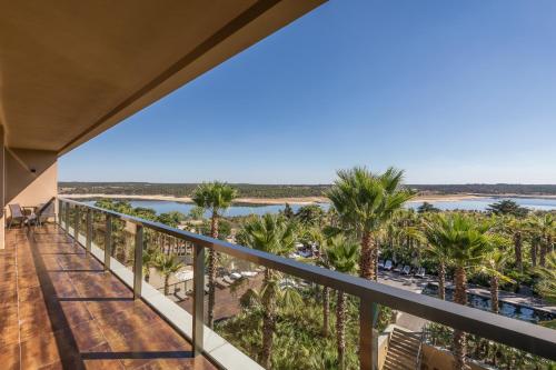 a view from the balcony of a resort with palm trees at AP Lago Montargil - Conference & SPA in Montargil