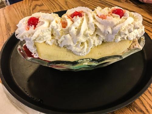 a pie with whipped cream and cherries on a plate at CDM 303 - Sandy Seashore Solace in Galveston