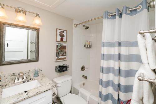 a bathroom with a sink and a toilet and a tub at CDM 314 - Buoy Oh Buoy! in Galveston