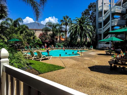 a swimming pool with chairs and people in it at CDM 304 - Beachfront Serenity in Galveston