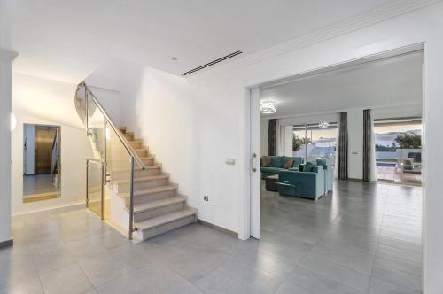 a living room with a staircase in a house at Espectacular Villa Aurora By Paramount Holidays in Puerto de Santiago