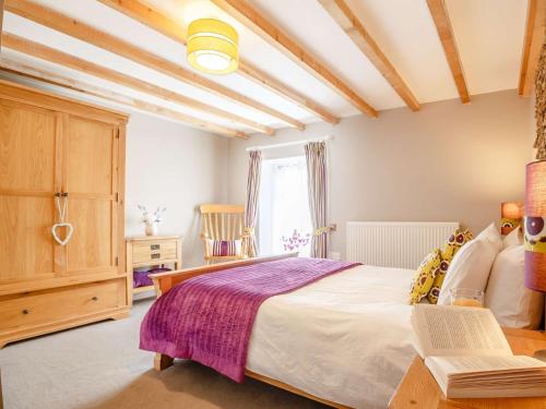 a bedroom with a bed and a table with a book at 1 bed in Bala 52510 in Corwen