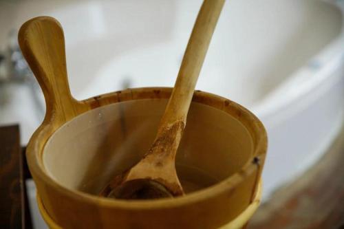 a wooden bowl with two wooden spoons in it at Agriturismo Podere Bucine Basso in Lari