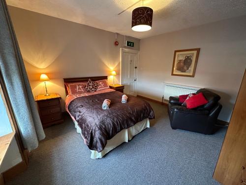 a bedroom with a large bed and a chair at Central Lisburn Accommodation in Lisburn