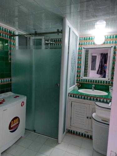 a bathroom with a shower and a sink at Villa Azaiiza in Sousse