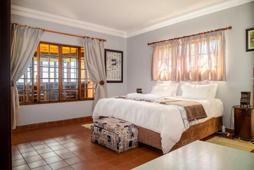 a bedroom with a large bed and a window at Moonlight Meadows just outside Dullstoom in Dullstroom