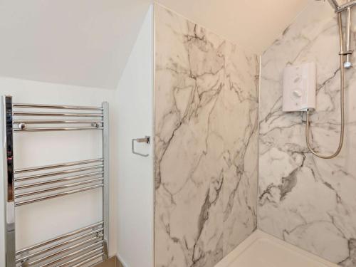 a bathroom with a shower with a marble wall at 9 Bed in Keswick SZ238 in Keswick