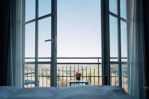 a bedroom with a bed and a window with a view at Klostermaier Hotel & Restaurant in Icking