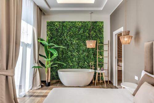 a bathroom with a tub in front of a green wall at ATAROOMS Suites Napoli in Naples
