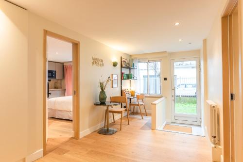 a living room with a table and a bedroom at Maison Letellier in Paris