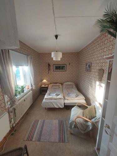 a bedroom with two twin beds and a window at Private Room in Pink House in Pajala