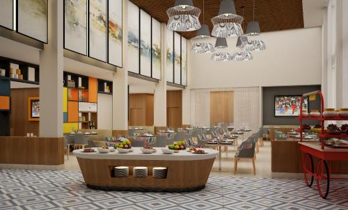a lobby with a cafeteria with tables and chairs at Zone by The Park Digha in Digha