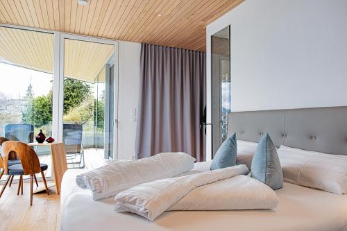 a bedroom with a large bed with pillows on it at Luxus-Apartements direkt am Attersee in Seewalchen