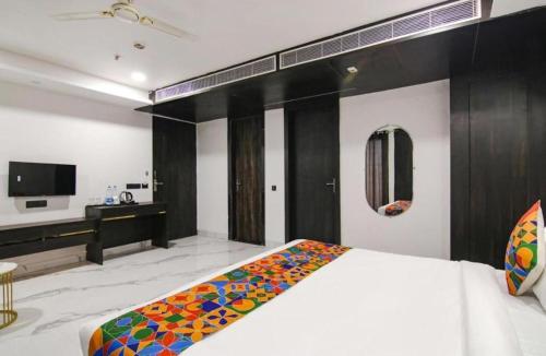 a bedroom with a bed and a desk in it at Hotel Grey Sky in New Delhi