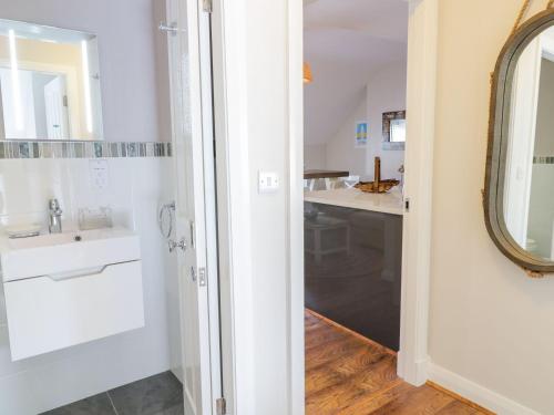 a bathroom with a sink and a mirror at UpTown - Manhattan House in Llandudno