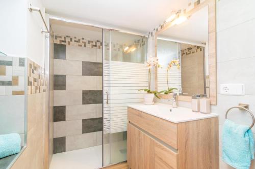 a bathroom with a sink and a shower at Villa Frontera in Sóller