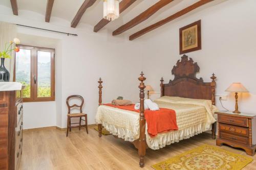 a bedroom with a bed and a table and a chair at Villa Frontera in Sóller