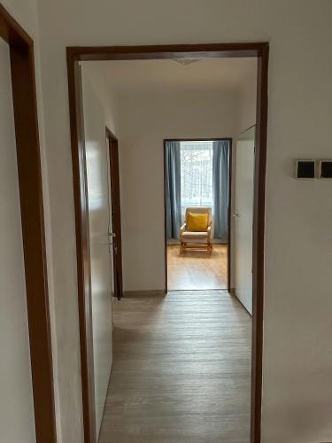 an open hallway with a yellow chair in a room at Řadovka Deštné in Deštné v Orlických horách