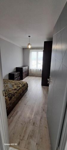 a bedroom with a bed and a wooden floor at Skyfall Rezidans in Kemerkoy