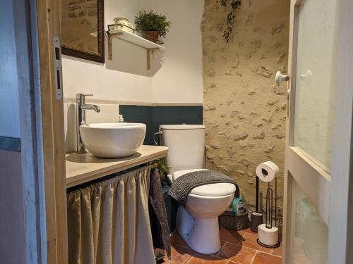 a bathroom with a sink and a toilet at Au bois radieux - option massage in Bellême