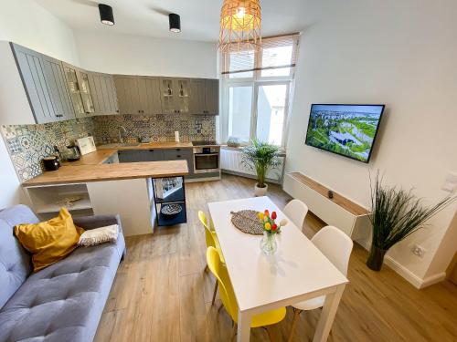 a kitchen and living room with a table and a couch at 34_Boho - DeerRest Apart in Jelenia Góra