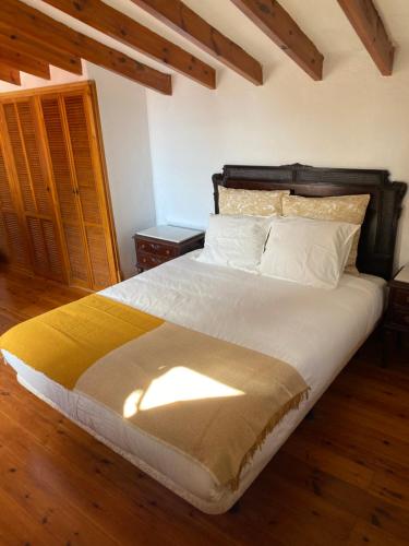 a bedroom with a large bed with a wooden headboard at Pink Lemon House in Elche