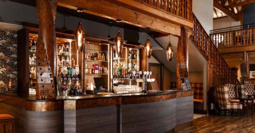 a bar with a lot of liquor bottles at Dunadry Hotel And Gardens in Antrim