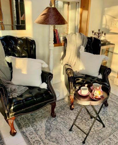 a living room with two chairs and a coffee table at Plantation House Bed & Breakfast in Port Hope
