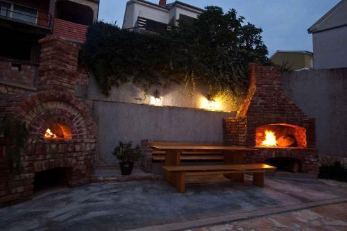 a wooden bench sitting in front of a brick oven at Apartment Crikvenica, Vinodol 2 in Crikvenica