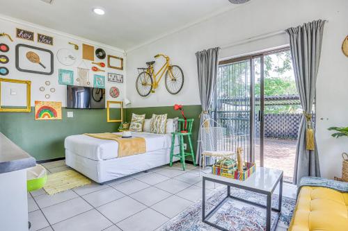 a bedroom with a bed and a bike on the wall at Chic Midtown Studio-1 Bed-solar-pool-fibre-samrand in Centurion