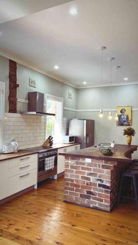 a kitchen with a brick island in the middle at Private and spacious home away from home in Dubbo in Dubbo