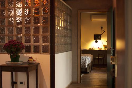 a room with a door to a room with a bedroom at La Lepre Bianca in Cento