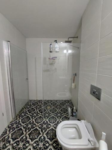 a bathroom with a shower and a toilet in it at Gindi Tower Apartments TLV in Tel Aviv